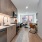 Model kitchen at The Glade on Laurel Apartments in Washington DC, featuring wood grain floor paneling and tiled backsplash.