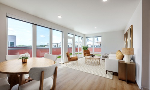 a living room with a couch, tables and chairs