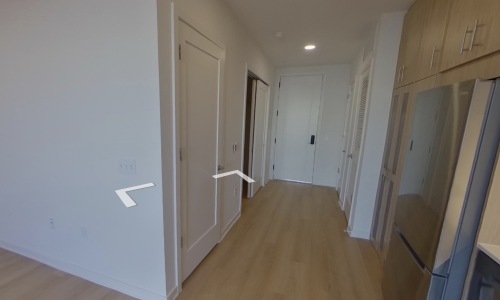 Virtual tour of the kitchen at The Glade on Laurel Apartments in Washington DC, featuring wood grain floor paneling.